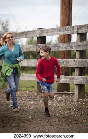 A Mother Plays Tag With Her Son; Everson Washington United States Of America View Large Photo Image Stock Photo - A Mother Plays Tag With Her Son; Everson Washington United States Of America. Fotosearch