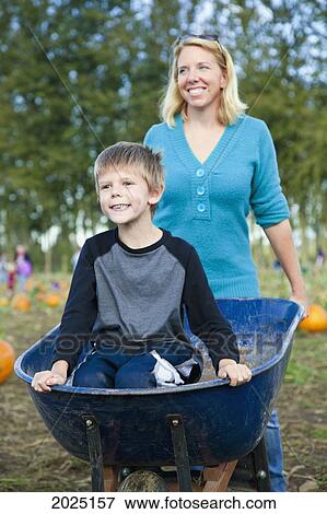A Mother Pushes Her Son In A Wheelbarrow At A Pumpkin Patch; Everson Washington United States Of America View Large Photo Image Stock Photo - A Mother Pushes Her Son In A Wheelbarrow At A Pumpkin Patch; Everson Washington United States Of America. Fotosearch