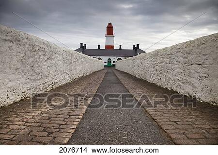 A path leading to a red and white lighthouse; south shields tyne and wear england View Large Photo Image Picture - A path leading to a red and white lighthouse; south shields tyne and wear england. Fotosearch