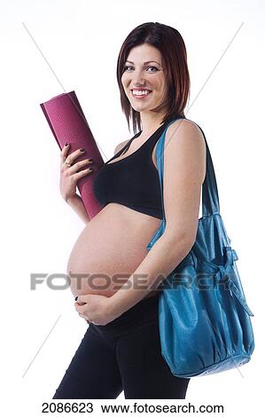 A pregnant woman holding her workout mat and purse; edmonton alberta canada View Large Photo Image Stock Image - A pregnant woman holding her workout mat and purse; edmonton alberta canada. Fotosearch