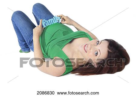 A pregnant woman lays on her back with a sign saying 'family' on her belly; edmonton alberta canada View Large Photo Image Stock Image - A pregnant woman lays on her back with a sign saying 'family' on her belly; edmonton alberta canada. Fotosearch