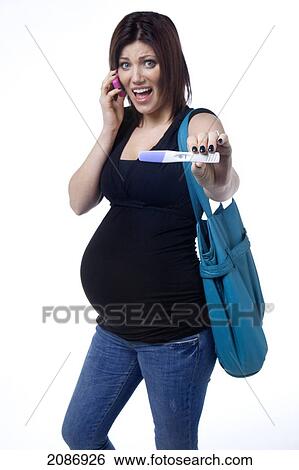 A pregnant woman on a cell phone holding her positive pregnancy test; edmonton alberta canada View Large Photo Image Stock Photograph - A pregnant woman on a cell phone holding her positive pregnancy test; edmonton alberta canada. Fotosearch