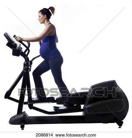A pregnant woman using fitness equipment; edmonton alberta canada View Large Photo Image Picture - A pregnant woman using fitness equipment; edmonton alberta canada. Fotosearch