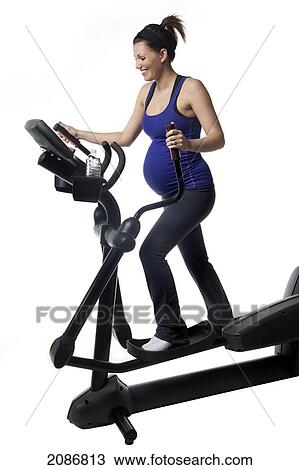 A pregnant woman using fitness equipment; edmonton alberta canada View Large Photo Image Stock Image - A pregnant woman using fitness equipment; edmonton alberta canada. Fotosearch