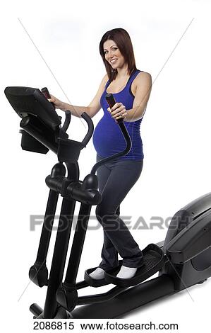 A pregnant woman using fitness equipment; edmonton alberta canada View Large Photo Image Stock Photography - A pregnant woman using fitness equipment; edmonton alberta canada. Fotosearch