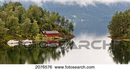 A red building and boats moored at the water's edge of a tranquil lake; View Large Photo Image Stock Photograph - A red building and boats moored at the water's edge of a tranquil lake;. Fotosearch