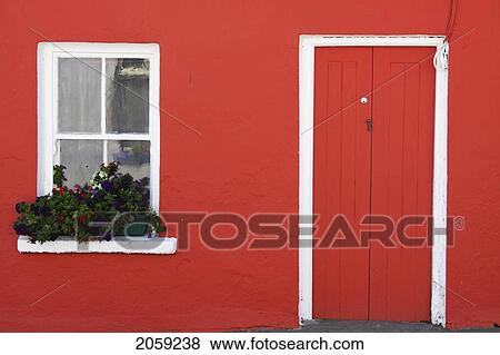 Stock Photo - A Red Painted House With Flower Box In The Window; Eyeries County Cork Ireland. Fotosearch