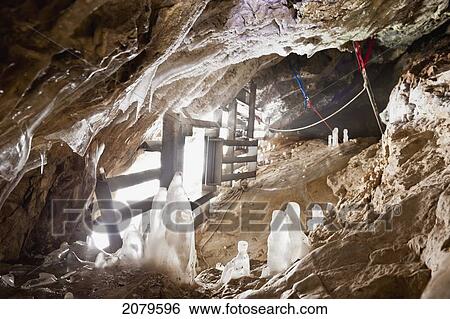 Stock Photograph - A rigged gated winter alberta cave mouth; canmore alberta canada. Fotosearch