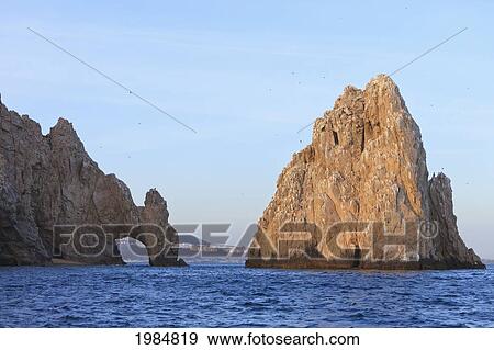 A Rock Formation In The Water On The Coast; Cabo San Lucas Baja California Sur Mexico View Large Photo Image Stock Photo - A Rock Formation In The Water On The Coast; Cabo San Lucas Baja California Sur Mexico. Fotosearch