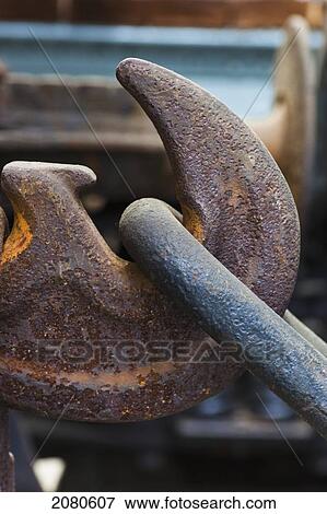 Stock Photo - A rusty hook holding a chain; shildon durham england. Fotosearch