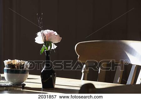 Stock Photo - A Single Rose Sits In A Small Vase On A Restaurant Table; Northumberland England. Fotosearch
