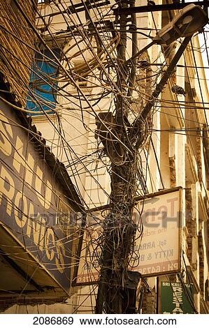 Stock Photo - A tangle of wires and cables on a transmission pole; agra uttar pradesh india. Fotosearch