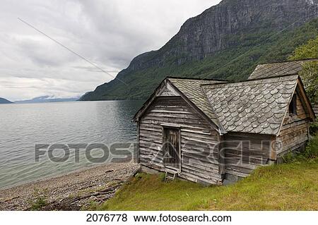 A weathered wooden house along the water's edge; hardangervidda norway View Large Photo Image Stock Photo - A weathered wooden house along the water's edge; hardangervidda norway. Fotosearch