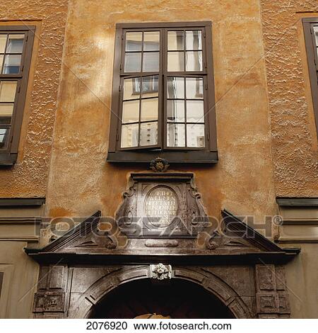 Stock Image - A window ajar above the doorway of a building in old town; stockholm sweden. Fotosearch