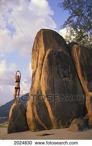 A Woman Does Stretches And Yoga On The Beach Of A Tropical Island; Koh Lanta Krabi Province Thailand View Large Photo Image Stock Image - A Woman Does Stretches And Yoga On The Beach Of A Tropical Island; Koh Lanta Krabi Province Thailand. Fotosearch