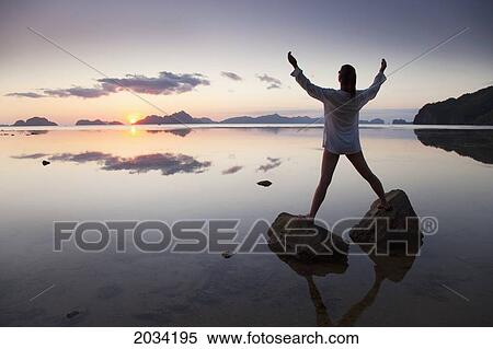 A Woman Gives Praise At The Beach; Corong Corong Bacuit Archipelago Palawan Philippines View Large Photo Image Stock Photography - A Woman Gives Praise At The Beach; Corong Corong Bacuit Archipelago Palawan Philippines. Fotosearch