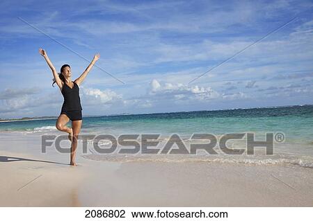 A woman in a yoga pose on the beach; punta cana la altagracia dominican republic View Large Photo Image Stock Image - A woman in a yoga pose on the beach; punta cana la altagracia dominican republic. Fotosearch