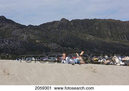A Woman Lays On A Sandy Beach Near Allies; County Cork Ireland View Large Photo Image Stock Image - A Woman Lays On A Sandy Beach Near Allies; County Cork Ireland. Fotosearch