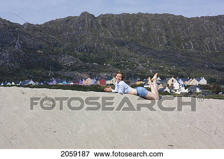 A Woman Lies On A Sandy Beach Near Allihies; County Cork Ireland View Large Photo Image Stock Photo - A Woman Lies On A Sandy Beach Near Allihies; County Cork Ireland. Fotosearch