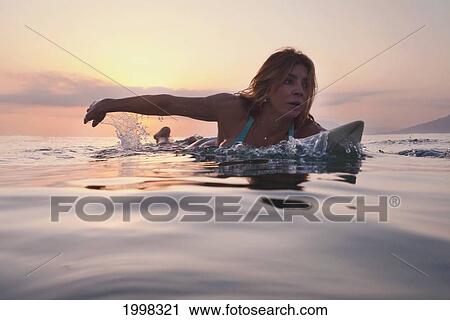 A Woman Paddling On A Surfboard At Sunset; Tarifa Cadiz Andalusia Spain View Large Photo Image Stock Image - A Woman Paddling On A Surfboard At Sunset; Tarifa Cadiz Andalusia Spain. Fotosearch