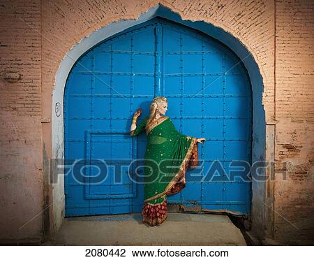 A woman posing in a doorway wearing a sari; ludhiana punjab india View Large Photo Image Stock Image - A woman posing in a doorway wearing a sari; ludhiana punjab india. Fotosearch