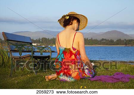 A Woman Reads A Book By The Water's Edge; County Kerry Ireland View Large Photo Image Stock Image - A Woman Reads A Book By The Water's Edge; County Kerry Ireland. Fotosearch