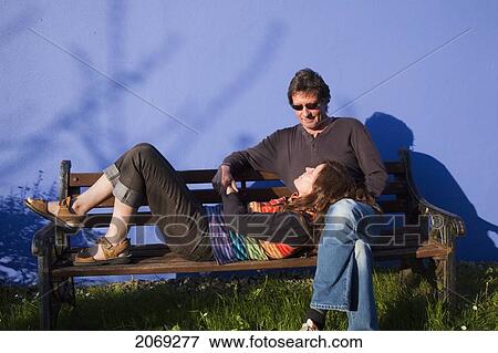 A Woman Rests Her Head In A Man's Lap On A Park Bench; Eyeries County Cork Ireland View Large Photo Image Stock Photo - A Woman Rests Her Head In A Man's Lap On A Park Bench; Eyeries County Cork Ireland. Fotosearch