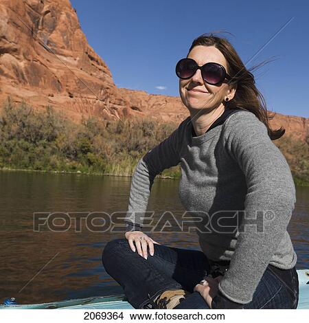 A Woman Sits On A Boat On The Colorado River; Arizona United States Of America View Large Photo Image Picture - A Woman Sits On A Boat On The Colorado River; Arizona United States Of America. Fotosearch