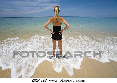 A Woman Stands In The Shallow Clear Waters Of A Tropical Island; Koh Lanta Krabi Province Thailand View Large Photo Image Stock Photo - A Woman Stands In The Shallow Clear Waters Of A Tropical Island; Koh Lanta Krabi Province Thailand. Fotosearch