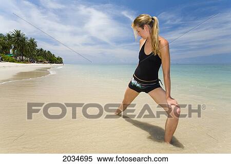 A Woman Tourist Does Yoga On A Tropical Island; Koh Lanta Thailand View Large Photo Image Stock Photography - A Woman Tourist Does Yoga On A Tropical Island; Koh Lanta Thailand. Fotosearch