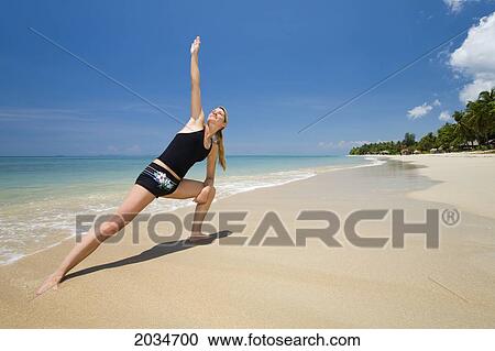 A Woman Tourist Does Yoga On The Beach Of A Tropical Island; Koh Lanta Thailand View Large Photo Image Stock Image - A Woman Tourist Does Yoga On The Beach Of A Tropical Island; Koh Lanta Thailand. Fotosearch