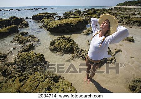 A Woman Tourist Enjoys The Sunshine On The Beach Of A Tropical Island; Koh Lanta Thailand View Large Photo Image Picture - A Woman Tourist Enjoys The Sunshine On The Beach Of A Tropical Island; Koh Lanta Thailand. Fotosearch
