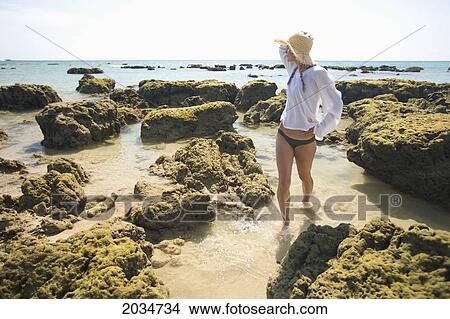 A Woman Tourist Enjoys The Sunshine On The Beach Of A Tropical Island; Koh Lanta Thailand View Large Photo Image Picture - A Woman Tourist Enjoys The Sunshine On The Beach Of A Tropical Island; Koh Lanta Thailand. Fotosearch
