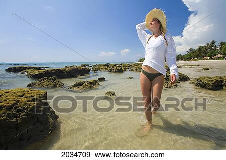 A Woman Tourist Enjoys The Sunshine On The Beach Of A Tropical Island; Koh Lanta Thailand View Large Photo Image Stock Photo - A Woman Tourist Enjoys The Sunshine On The Beach Of A Tropical Island; Koh Lanta Thailand. Fotosearch