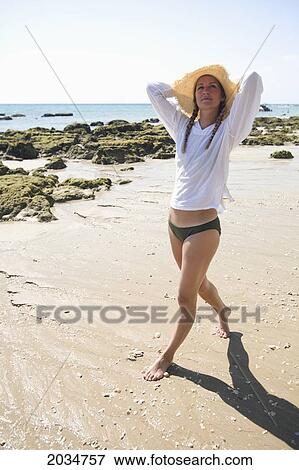 A Woman Tourist Enjoys The Sunshine On The Beach Of A Tropical Island; Koh Lanta Thailand View Large Photo Image Stock Photo - A Woman Tourist Enjoys The Sunshine On The Beach Of A Tropical Island; Koh Lanta Thailand. Fotosearch
