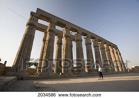 A Woman Tourist Looks Up At The Columns In The Luxor Temple; Luxor Egypt View Large Photo Image Stock Photograph - A Woman Tourist Looks Up At The Columns In The Luxor Temple; Luxor Egypt. Fotosearch