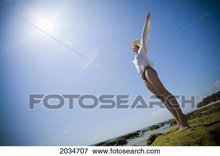 A Woman Tourist Raises Her Arms On The Beach Of A Tropical Island; Koh Lanta Thailand View Large Photo Image Stock Photo - A Woman Tourist Raises Her Arms On The Beach Of A Tropical Island; Koh Lanta Thailand. Fotosearch