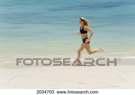 A Woman Tourist Runs Along The Beach On A Tropical Island; Koh Lanta Thailand View Large Photo Image Stock Image - A Woman Tourist Runs Along The Beach On A Tropical Island; Koh Lanta Thailand. Fotosearch