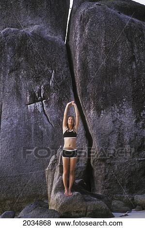 A Woman Tourist Stretches And Does Yoga On The Beach Of A Tropical Island; Koh Tao Thailand View Large Photo Image Stock Photo - A Woman Tourist Stretches And Does Yoga On The Beach Of A Tropical Island; Koh Tao Thailand. Fotosearch
