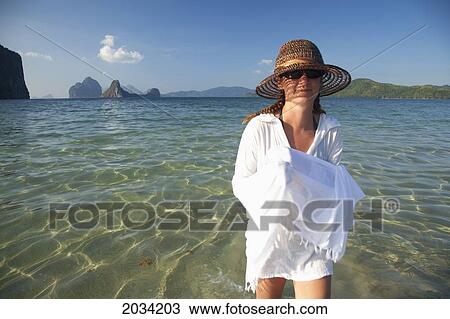 A Woman Tourist Walks In Shallow Clear Water On A Sand Island Near El Nido And Corong Corong; Bacuit Archipelago Palawan Philippines View Large Photo Image Stock Image - A Woman Tourist Walks In Shallow Clear Water On A Sand Island Near El Nido And Corong Corong; Bacuit Archipelago Palawan Philippines. Fotosearch