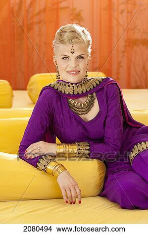 A woman wearing a purple sari for a pre-wedding mehndi ceremony; ludhiana punjab india View Large Photo Image Picture - A woman wearing a purple sari for a pre-wedding mehndi ceremony; ludhiana punjab india. Fotosearch