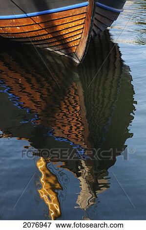 A wooden boat and it's reflection in the water; stockholm sweden View Large Photo Image Stock Photo - A wooden boat and it's reflection in the water; stockholm sweden. Fotosearch