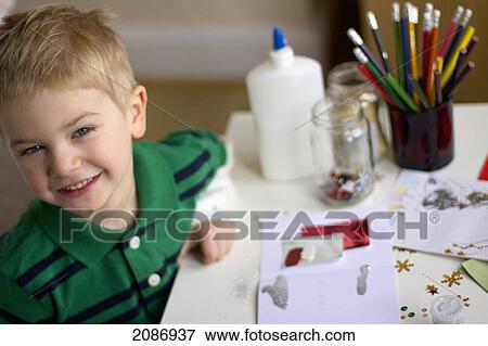 A young boy doing artwork; cambridge united kingdom View Large Photo Image Stock Photo - A young boy doing artwork; cambridge united kingdom. Fotosearch