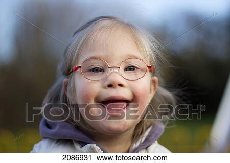 A young girl with down syndrome wearing eyeglasses; cambridge united kingdom View Large Photo Image Stock Image - A young girl with down syndrome wearing eyeglasses; cambridge united kingdom. Fotosearch