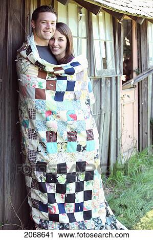 A Young Man And Young Woman Wrapped Together In A Blanket; Troutdale Oregon United States Of America View Large Photo Image Stock Image - A Young Man And Young Woman Wrapped Together In A Blanket; Troutdale Oregon United States Of America. Fotosearch