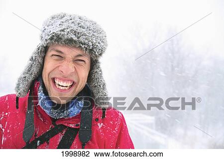 A Young Man Laughing A He Wears A Fur Hat Covered In Snow On A Snowy Day; Eagan Minnesota United States Of America View Large Photo Image Stock Image - A Young Man Laughing A He Wears A Fur Hat Covered In Snow On A Snowy Day; Eagan Minnesota United States Of America. Fotosearch