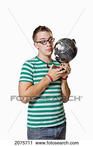 A Young Man Looks Closely At A Globe View Large Photo Image Stock Image - A Young Man Looks Closely At A Globe. Fotosearch