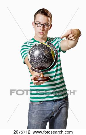A Young Man Points To A Globe View Large Photo Image Stock Image - A Young Man Points To A Globe. Fotosearch