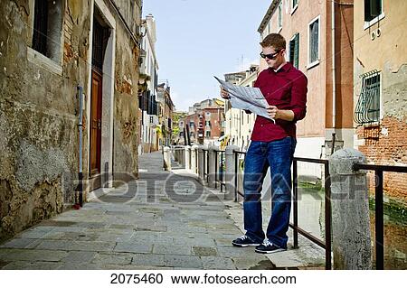 A Young Man Stands Reading A Map; Venice Italy View Large Photo Image Stock Image - A Young Man Stands Reading A Map; Venice Italy. Fotosearch