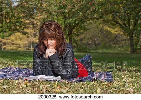 A Young Woman Reading A Bible And Meditating In A Park; Edmonton Alberta Canada View Large Photo Image Stock Photography - A Young Woman Reading A Bible And Meditating In A Park; Edmonton Alberta Canada. Fotosearch